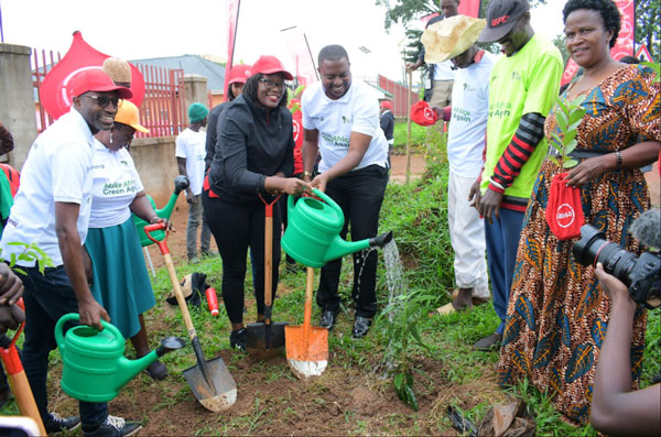 Absa’s Helen Basuuta Nangonzi, the Hoima City Mayor Brian Kaboyo, CEO Hostalite Dickson Mushabe at the tree planting launch in Hoima